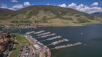 a marina on a body of water with a mountain in the background
